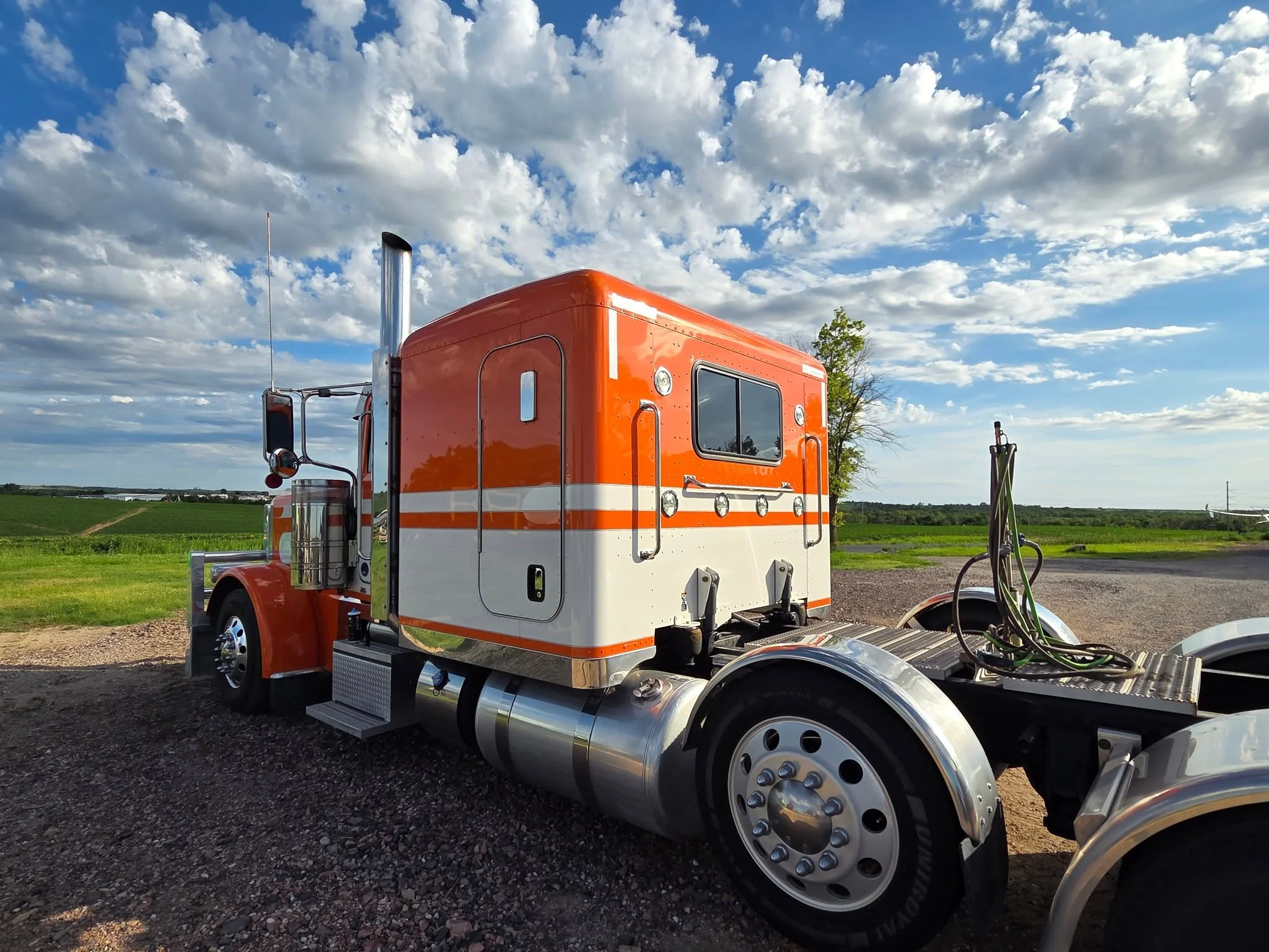 Orange and white Peterbilt semi cab detailed and polished