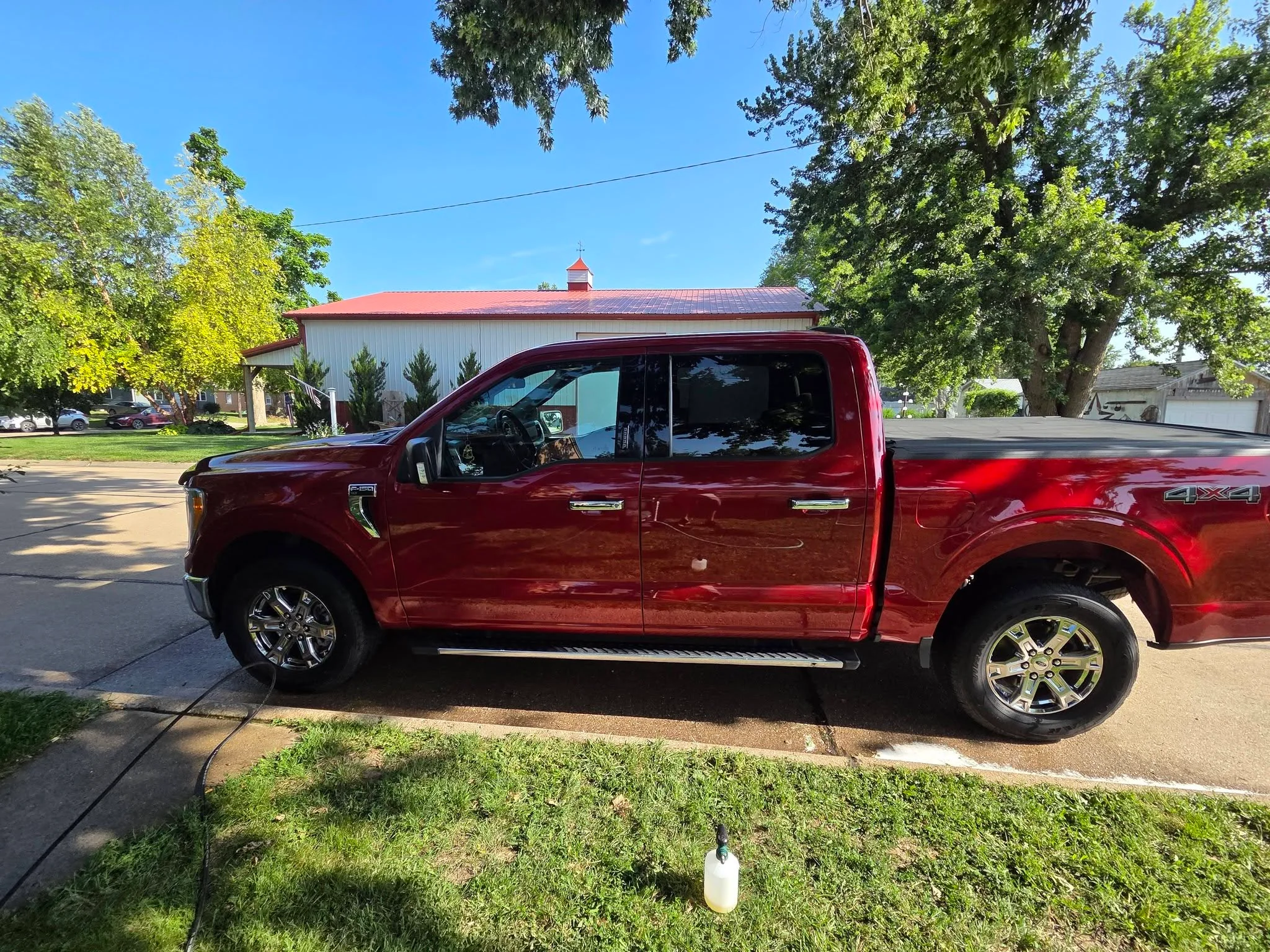 Red Ford Super Duty pickup detailed in a Deshler driveway